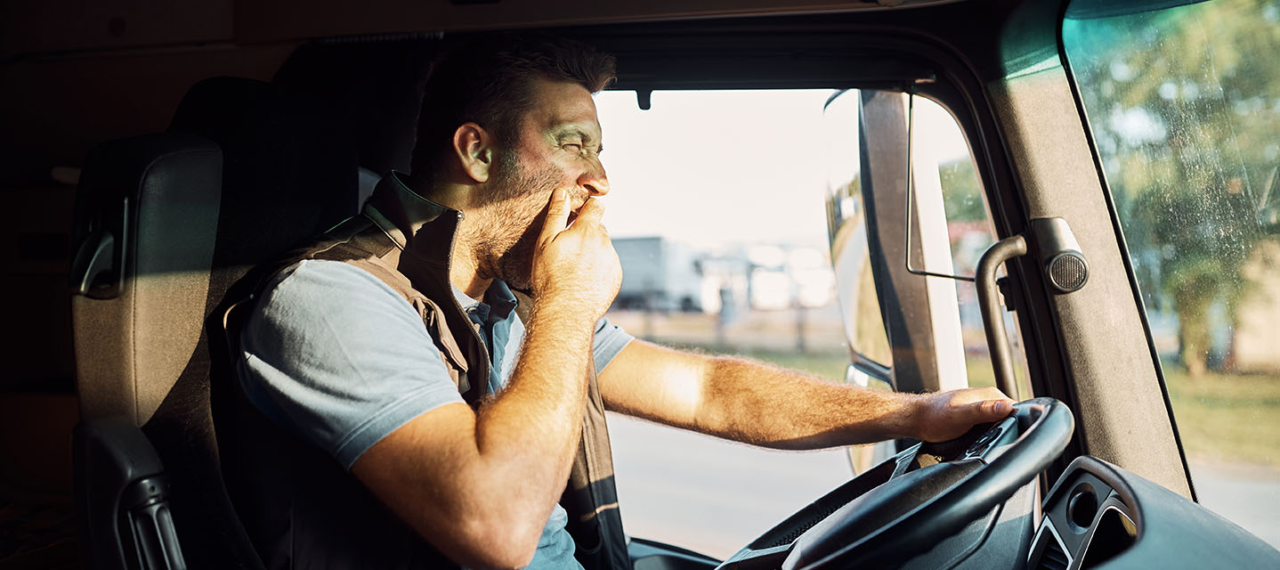 person yawning behind the wheel