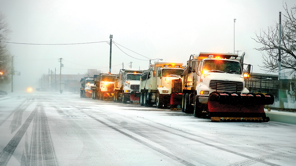 Snow plow clearing road