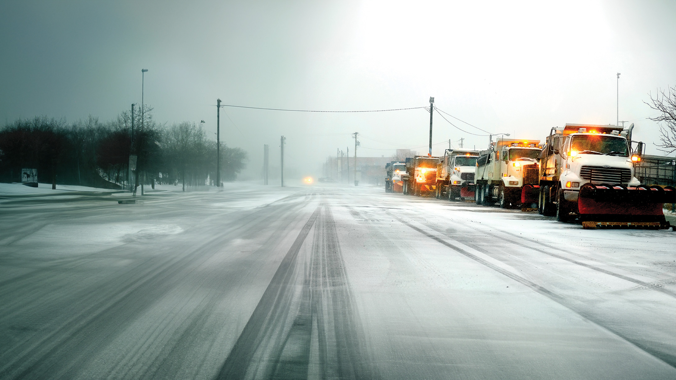 Snow plow clearing road