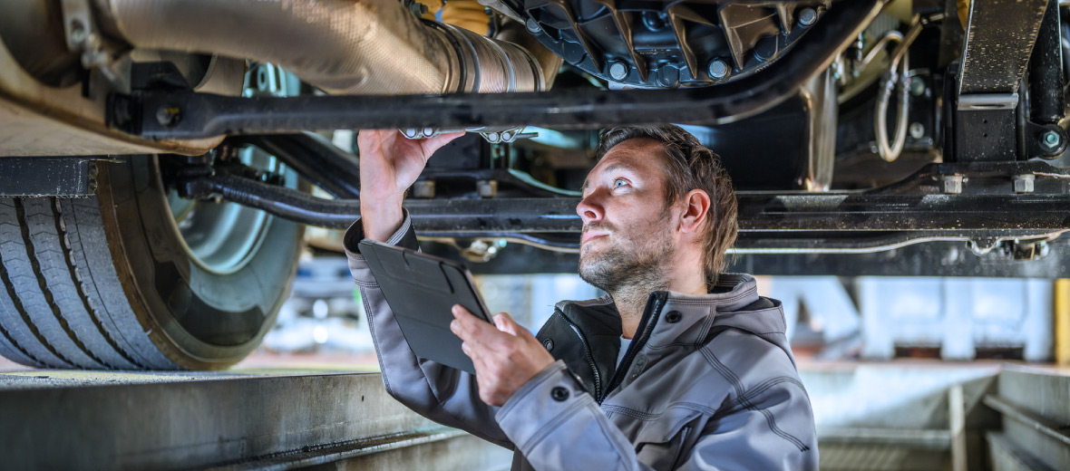 A technician performing maintenance on a fleet vehicle.