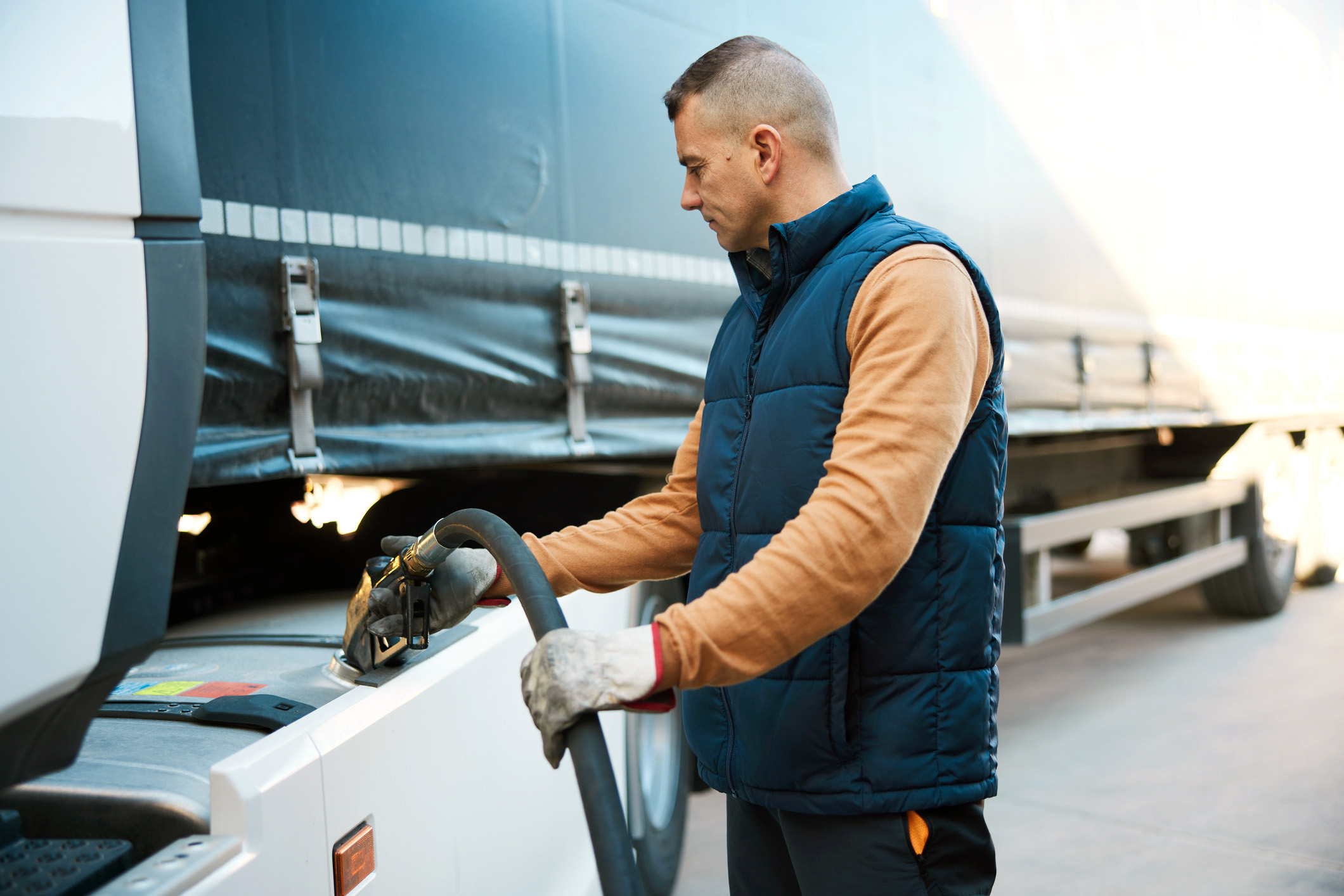 men putting gas to a vehicle