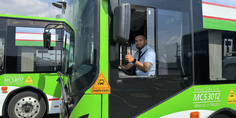 person giving thumbs up on a bus