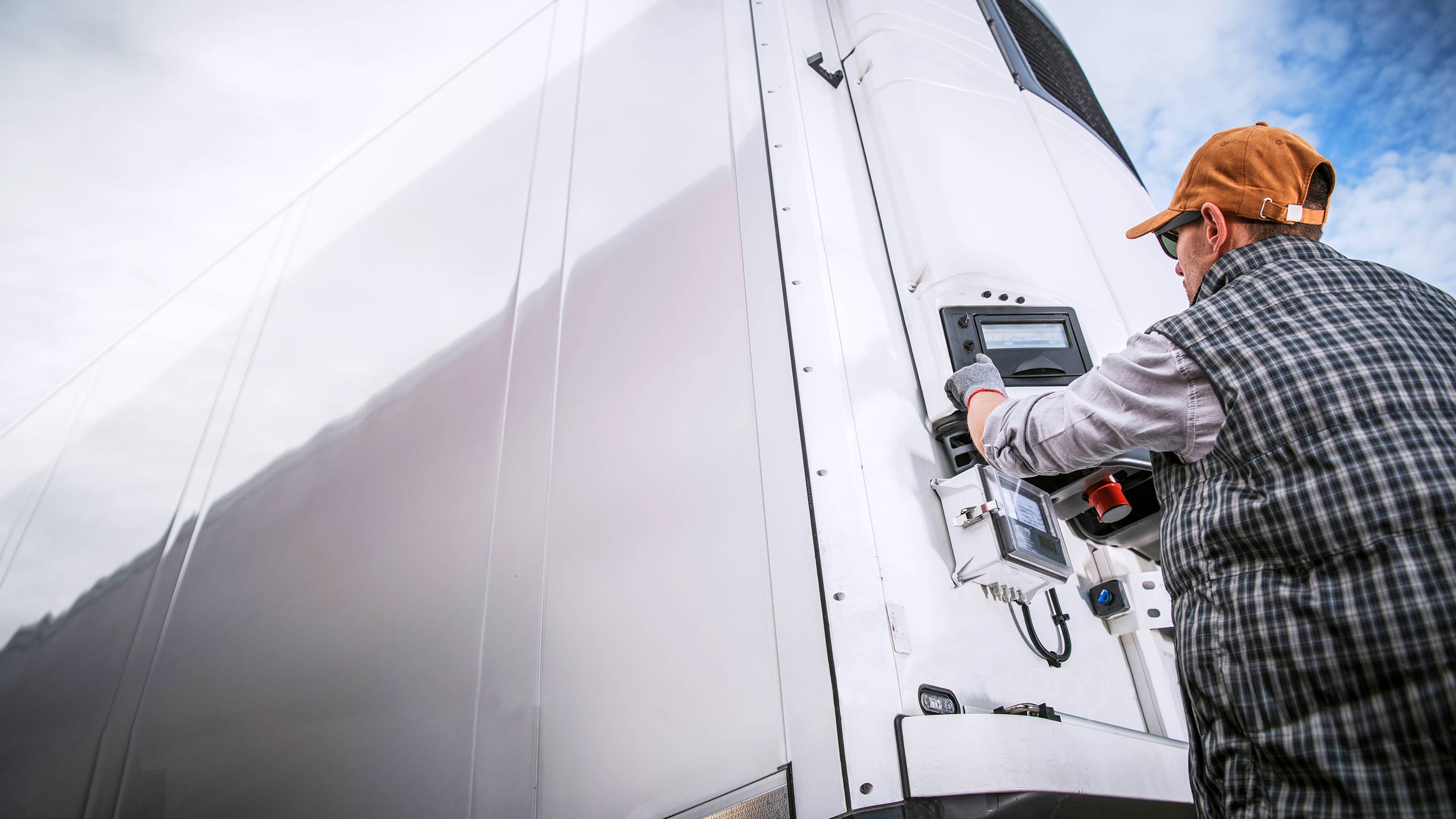 person working on a reefer trailer