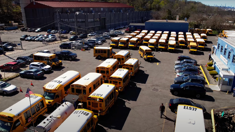 Large fleet of school busses in a parking lot 