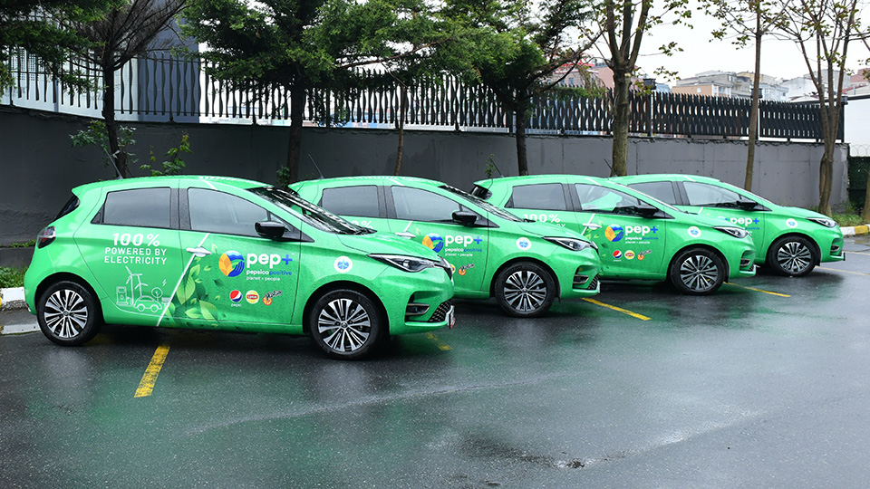 Row of green pepsico vehicles parked next to each other