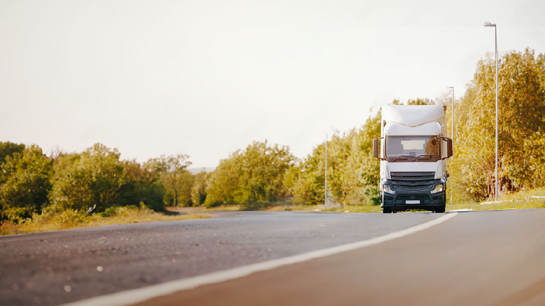 White truck driving on a countryroad