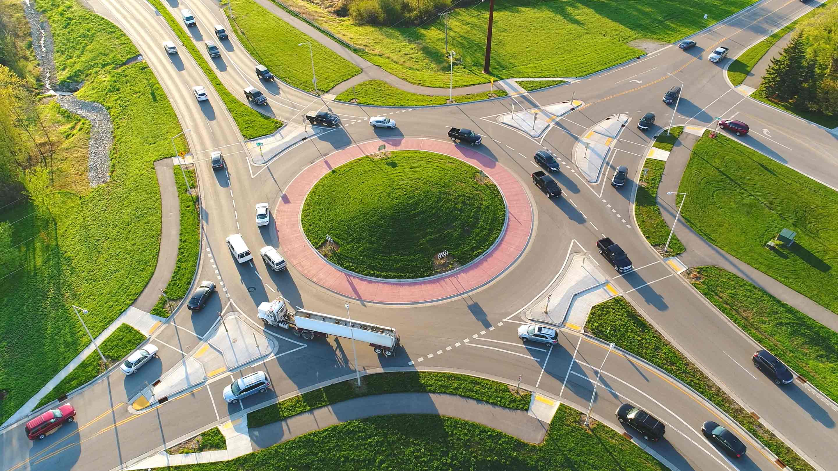 aerial view of cars driving through a roundabout