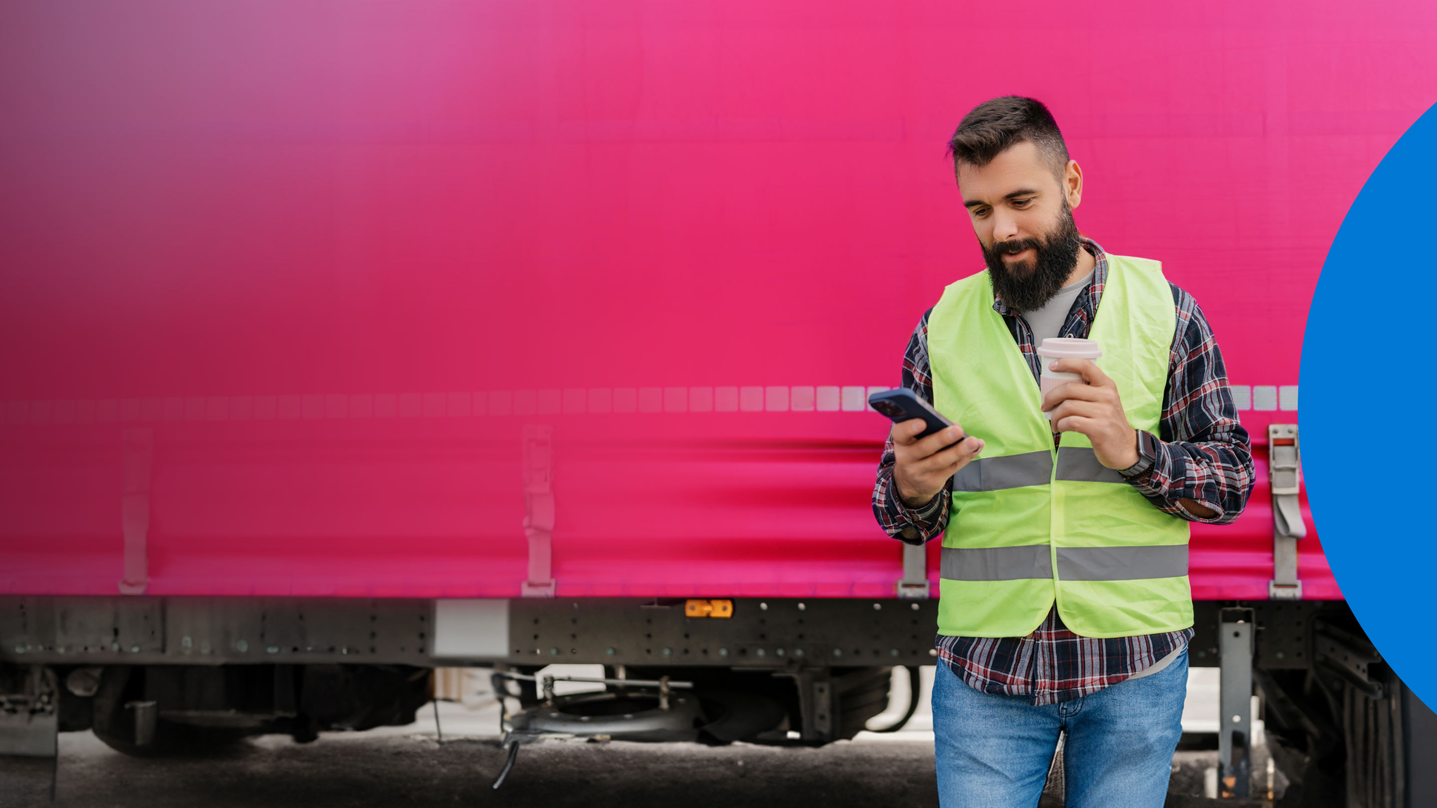 person standing outside using their phone and holding a coffee